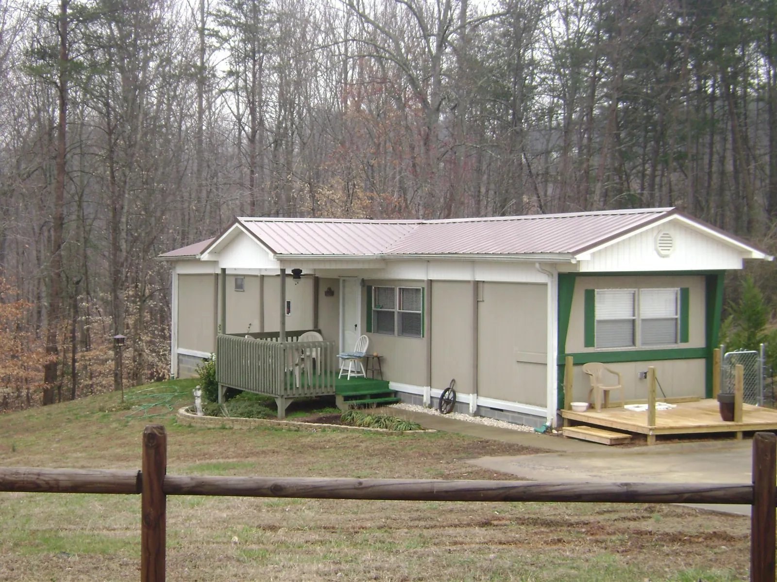 Mauve metal roof on a manufactured home with a new front deck in Newton